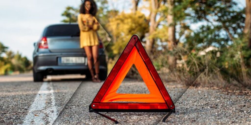 Woman ensuring safety while waiting for breakdown recovery company